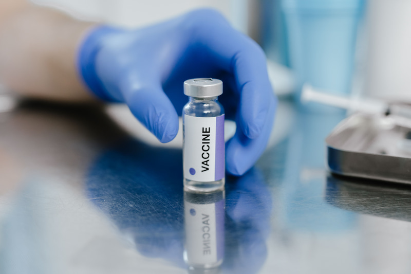 Vaccine vials and laboratory equipment representing Vaccine and Infectious Disease research